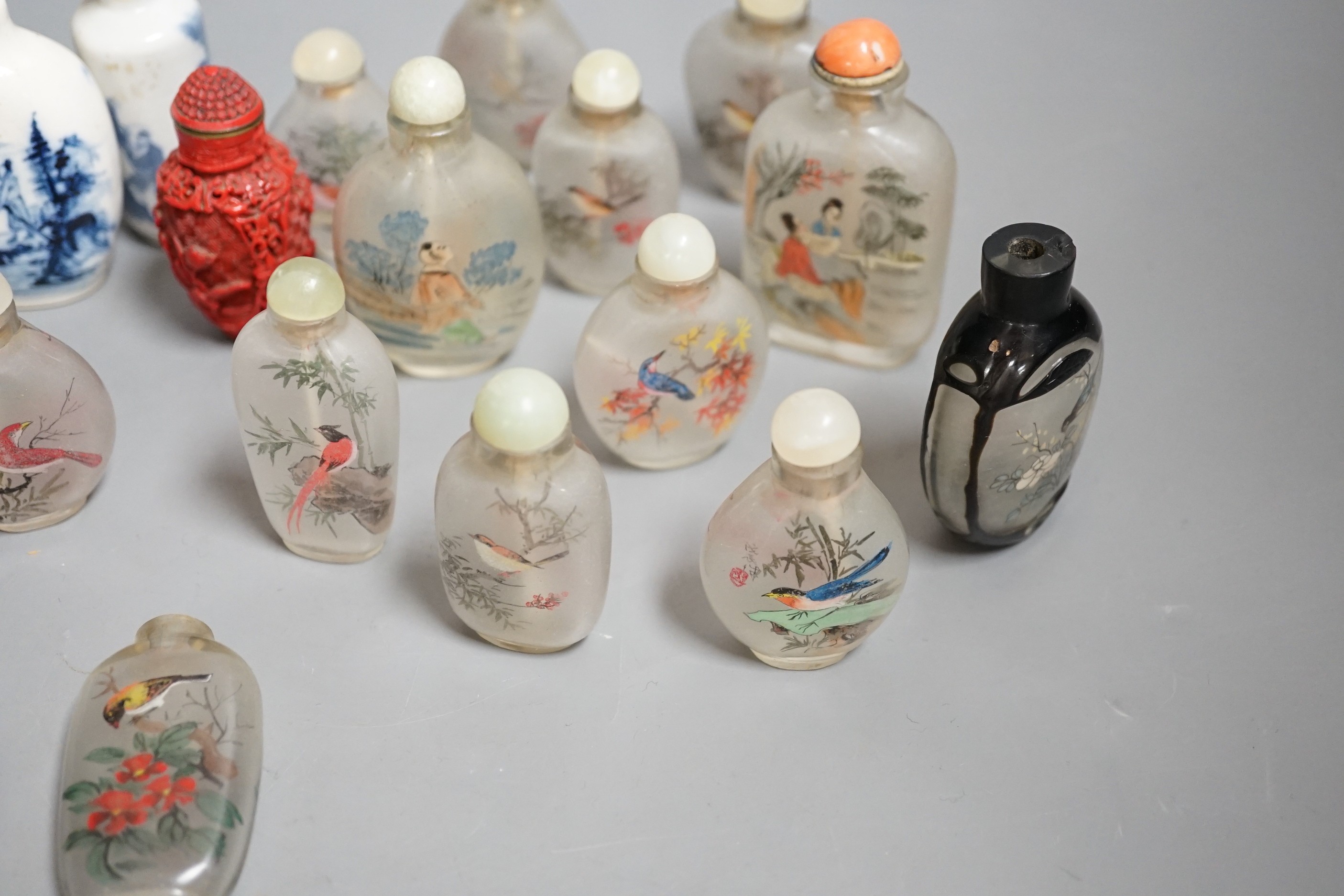 A collection of 20th century Chinese export reverse painted snuff bottles with associated blue and white porcelain examples, some 19th century